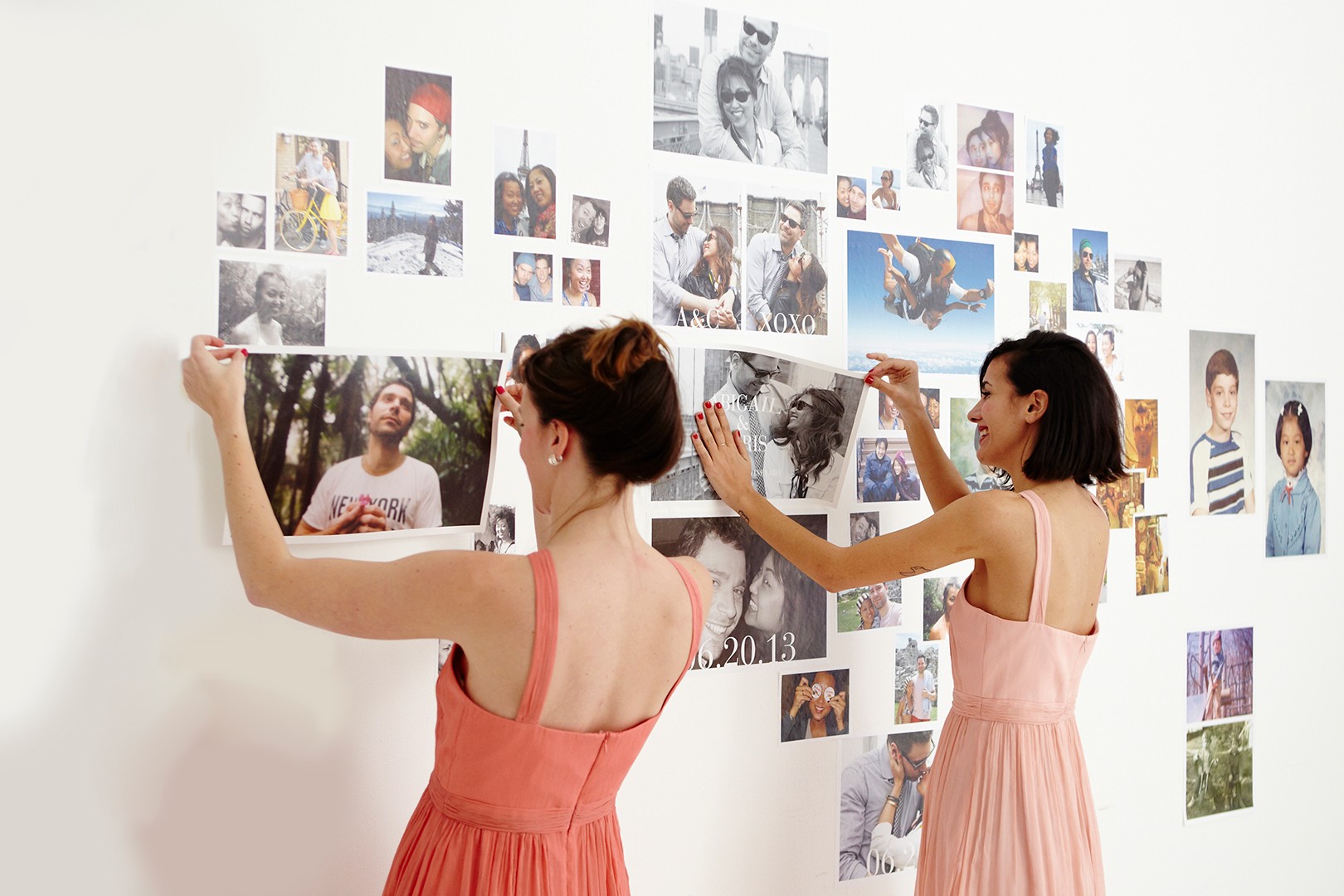 Bridesmaids putting up photo wall decal Collage for a wedding