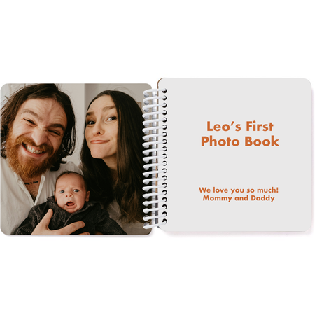 Opening title page of a personalized first year baby memory board book with custom text and photo