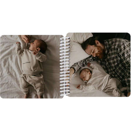 Father snuggling newborn in a personalized baby's first year photo board book
