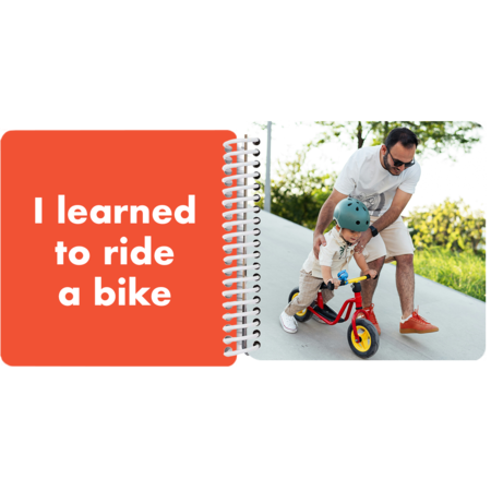 Child learning to ride a bike with dad in a personalized Year in Review board book with the milestone "I learned to ride a bike"