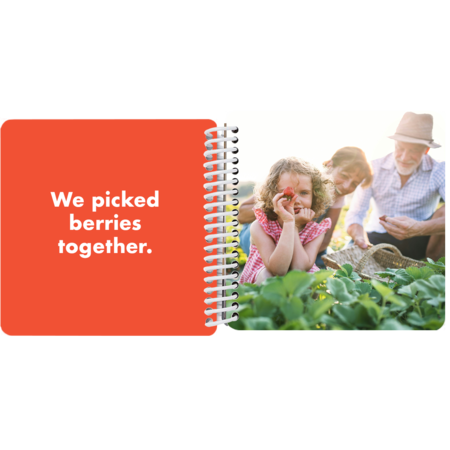 Grandfather and granddaughter picking berries together in a personalized Grandpa and Me board book with the message "We picked berries together"